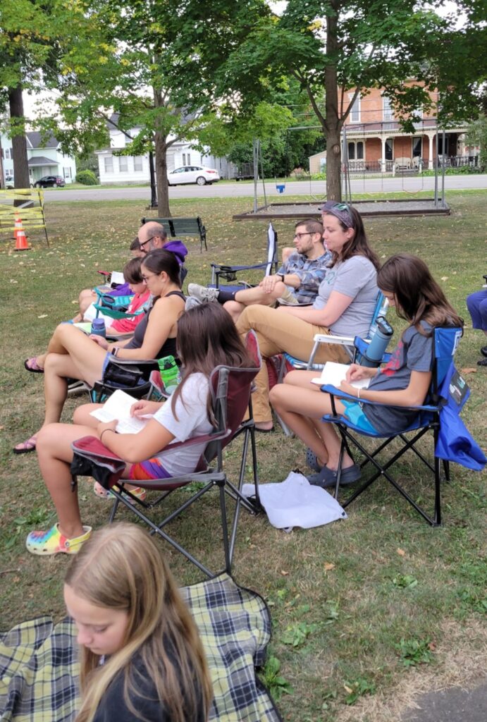 people reading in the park while listening to music