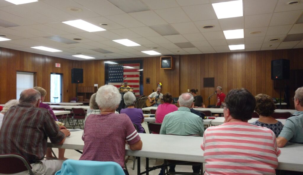 people in the townhall listening to a concert
