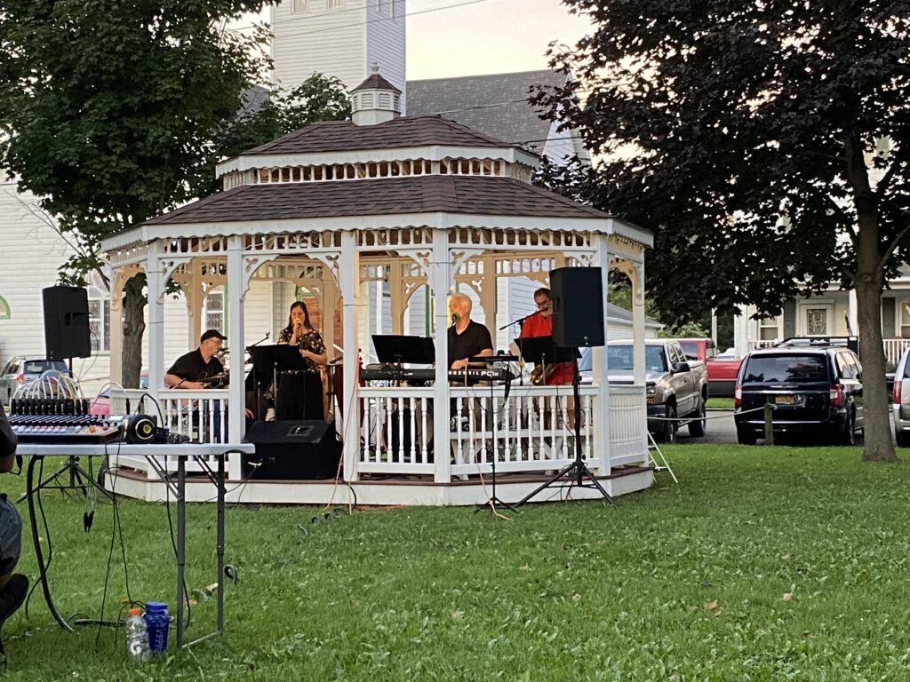 performers in a gazebo in the town park